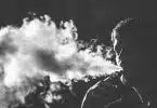 grayscale photography of smoking man