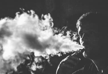 grayscale photography of smoking man